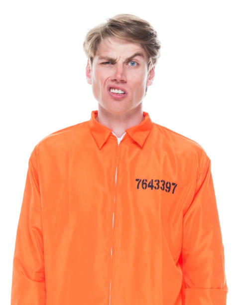 istock Male prisoner wearing orange jumpsuit 1145972569