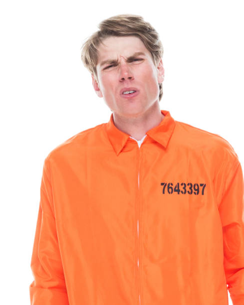 istock Male prisoner wearing orange jumpsuit 1145972578