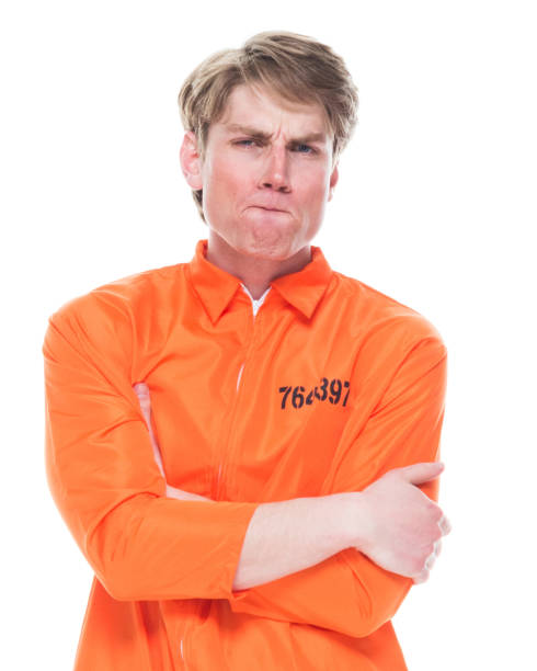 istock Male prisoner wearing orange jumpsuit 1145972733
