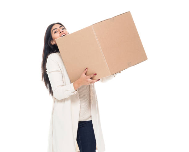 istock Attractive young latino female is holding a box 1145972789
