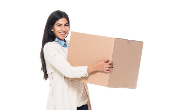 istock Attractive young latino female is holding a box 1145972914