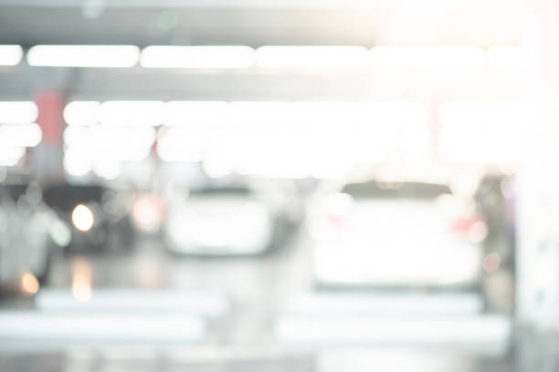 abstract blurred cars parked in parking lot of shopping mall. defocused background or backdrop for industrial and transportation concepts - stockyards industrial park imagens e fotografias de stock