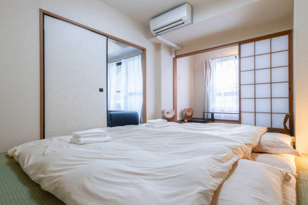 Japanese style mattress in a small bedroom Japanese style mattress in a small bedroom japanese akita stock pictures, royalty-free photos & images