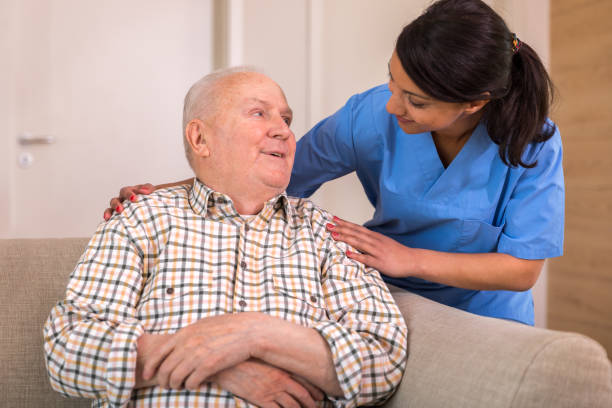 istock Nursing home - caregiver and senior man 1145988577