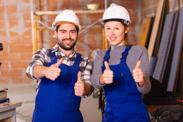 istock Portrait of two successful workers in uniform inside brick cottage 1145990199