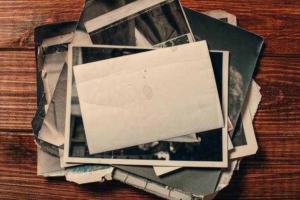 istock Stack old photos on table. Mock-up blank paper. Postcard rumpled and dirty vintage. Retro card 1145990419