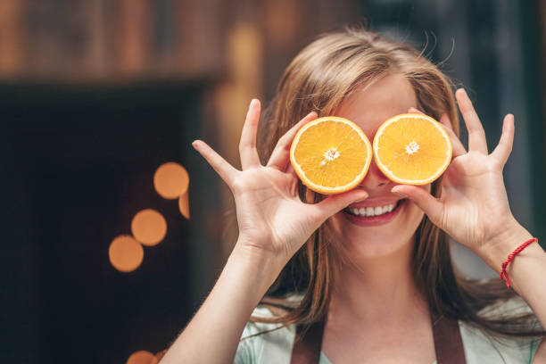 istock Happy girl with oranges 1145992035