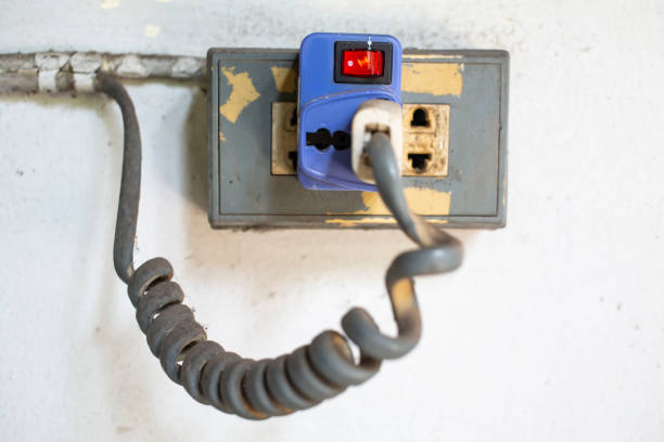 istock Old Electric Plug and Socket plugged on white concrete background, Close up shot, Electrical concept 1145992836