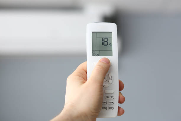 istock Male hand hold remote air conditioning 1145996219