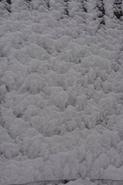 winter background, adhering snow, beautiful cut of large snow on a metal construction sheet with mounds and hollows. - adhering imagens e fotografias de stock
