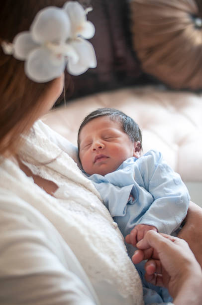 istock Young mother holding her newborn baby boy 1145997724