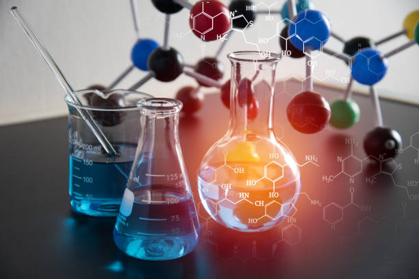 Digital Composite Image Of Liquids And Molecular Structure On Table  chemistry class stock pictures, royalty-free photos & images