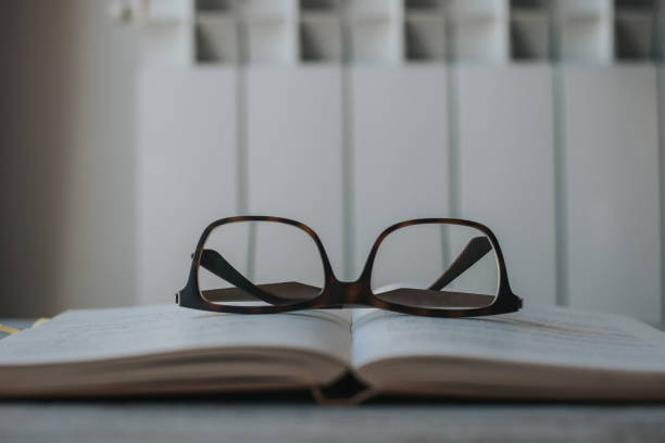 istock Close-Up Of Eyeglasses On Book At Table 1145999271