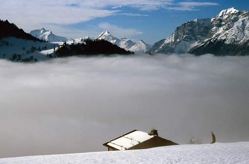 chalet above a sea of clouds in the French Alps