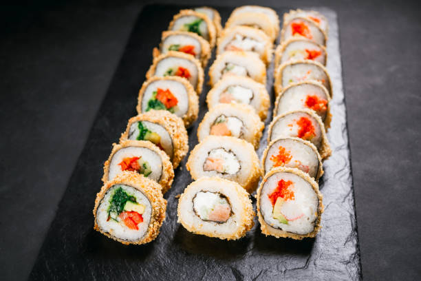 istock Tempura maki. Japanese sushi rolls set on slate 1146002946