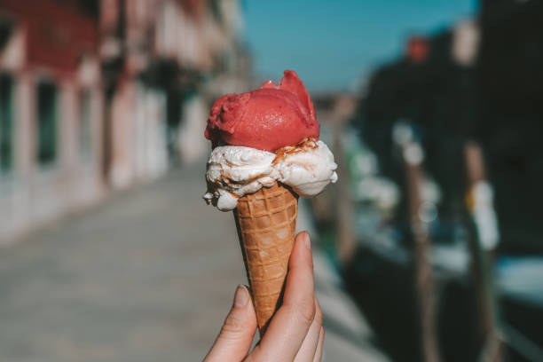 istock Cropped Hand Holding Ice Cream Cone In City 1146003185