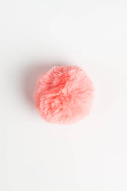 istock Coral fluffy fur ball on white background 1146004814