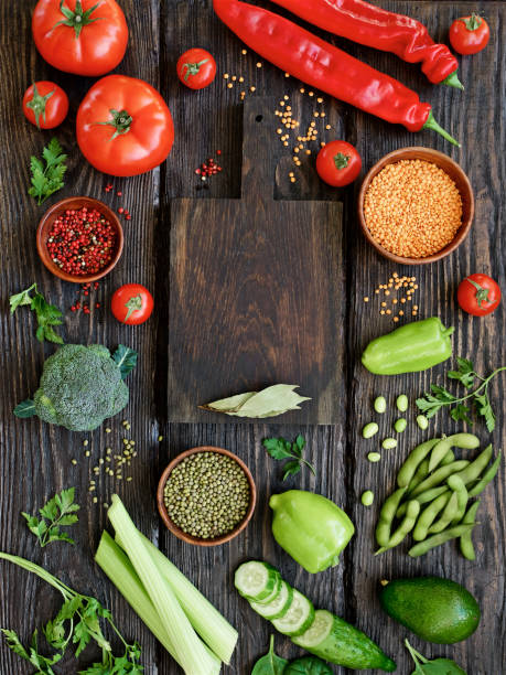 istock Combination of red and green vegetables and legumes, empty cutting board 1146005142