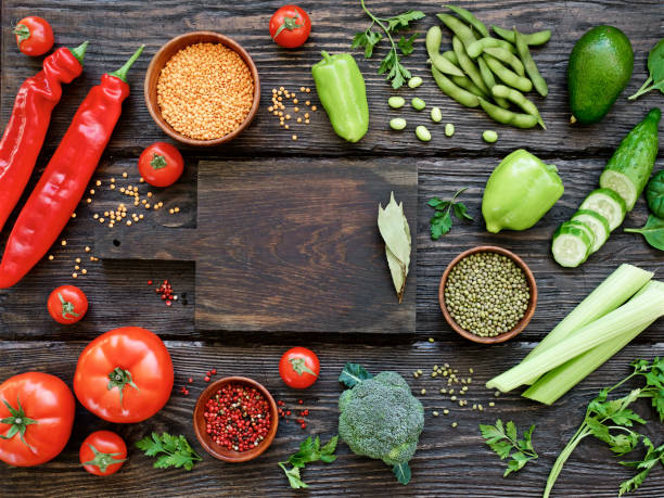 istock Combination of red and green vegetables and legumes, empty cutting board 1146005202