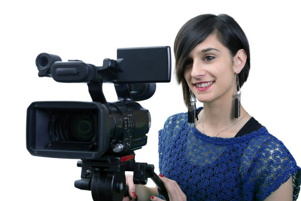 istock smiling young woman with professional video camera, on white 1146005325