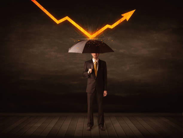 istock Businessman standing with umbrella keeping orange arrow 1146005759