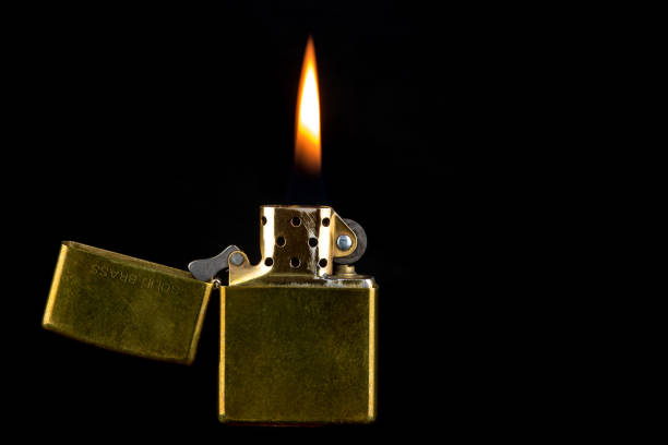 istock Old Brass Lighter and Flame on a Black Background 1146006953