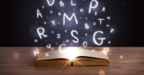 istock Open book with glowing letters flying out 1146007045