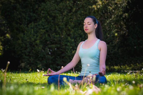 istock beautiful girl practicing yoga in the park 1146009402