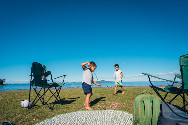 Mixed race kids enjoying outdoors. Camping outdoor at Waiake Bay, Auckland, New Zealand. rangitoto island stock pictures, royalty-free photos & images