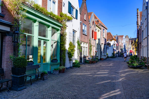 Street view in Deventer, Overijssel, Netherlands during a beautiful springtime day in the Hanseatic League city at the river IJssel. People are walking in the street in the background
