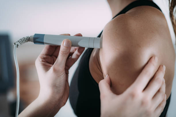 istock Laser therapy. Physical therapist treating patient's shoulder 1146012765
