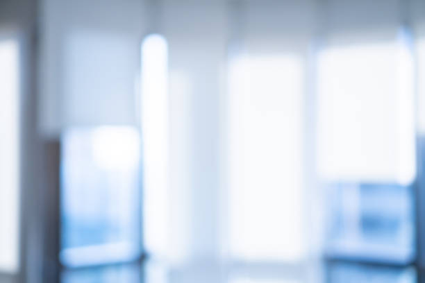 istock abstract blur inside interior of modern workplace in blue color background with shine light from window of buildings 1146014300