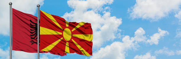 albania y macedonia bandera ondeando en el viento contra el cielo azul nublado blanco juntos. concepto de diplomacia, relaciones internacionales. - himno nacional turco fotografías e imágenes de stock