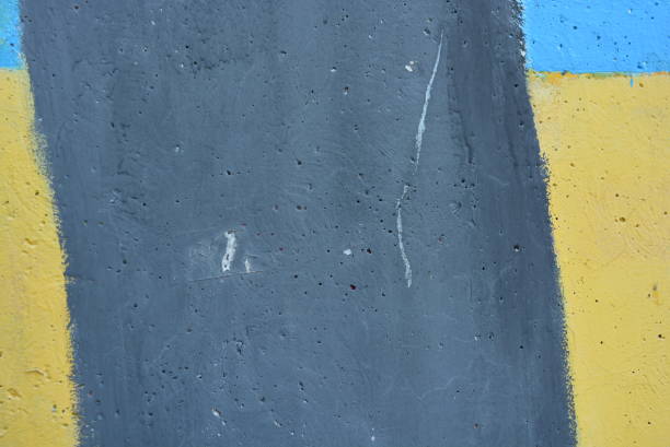 istock Concrete wall painted with yellow, blue and black paints. 1146019739