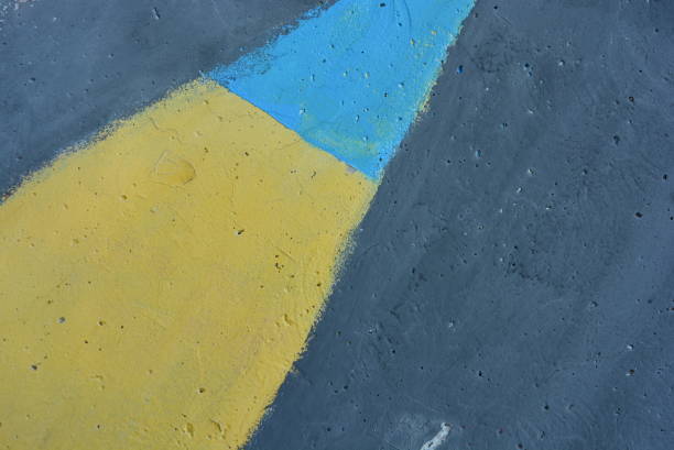 istock Concrete wall painted with yellow, blue and black paints. 1146019746