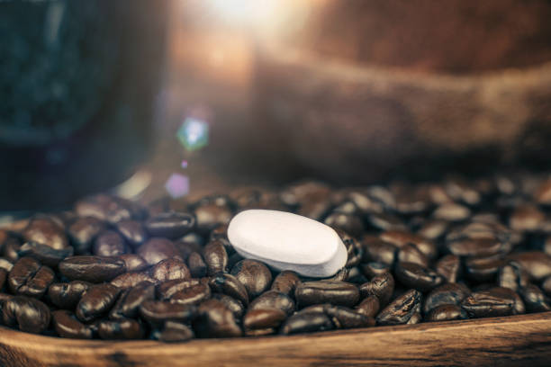 istock Caffeine Supplement Pill and Coffee Beans 1146023768