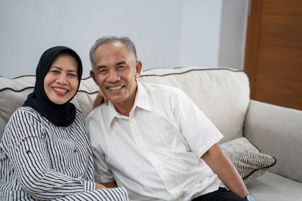 asian muslim eldery couple together portrait of young asian muslim eldery couple together smiling to camera malay couple stock pictures, royalty-free photos & images