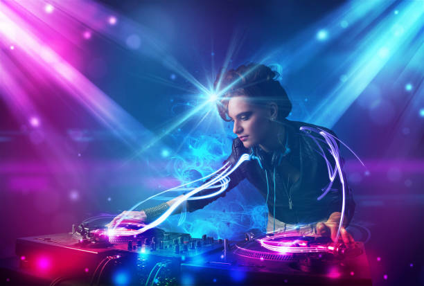 istock Energetic Dj girl mixing music with powerful light effects 1146025696