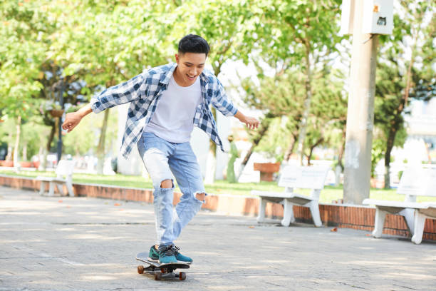 istock Yong trendy man having fun with skateboard 1146025859
