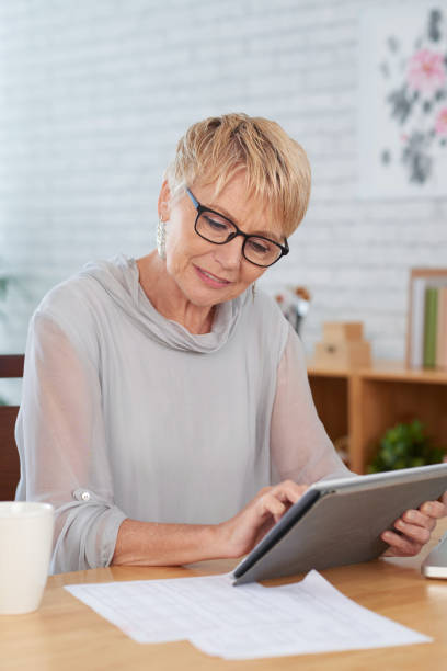 istock Woman working online on tablet pc 1146027315
