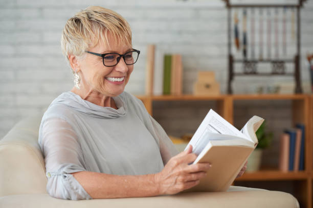istock Woman resting with book at home 1146027333