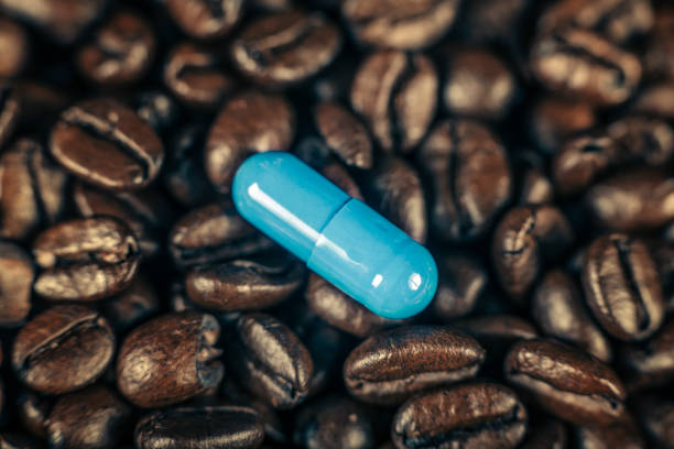 istock Caffeine Supplement Pill and Coffee Beans 1146028914