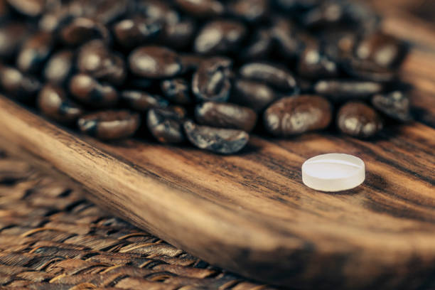 istock Caffeine Supplement Pill and Coffee Beans 1146029677