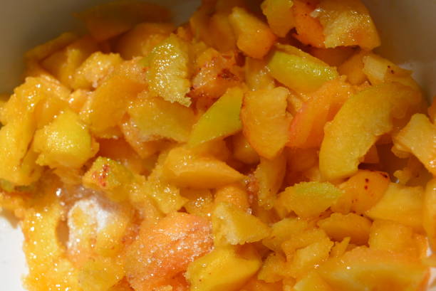 istock Fruit sliced pieces of freshly cut apricot cut with a knife and sprinkled with white sugar. 1146029708
