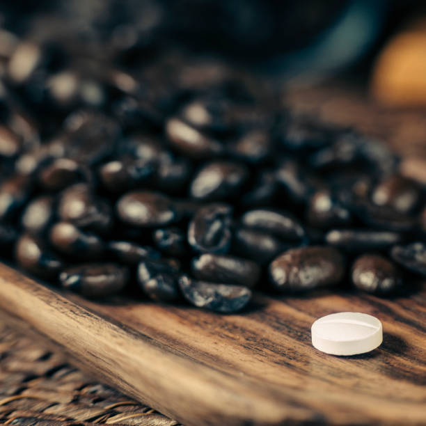 istock Caffeine Supplement Pill and Coffee Beans 1146029920