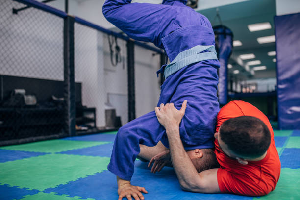 istock Two guys wrestling on the floor in gym 1146030253