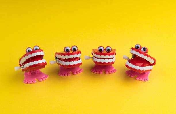 istock Four Clockwork Mouths Laughing and Staring on Yellow Background 1146033454