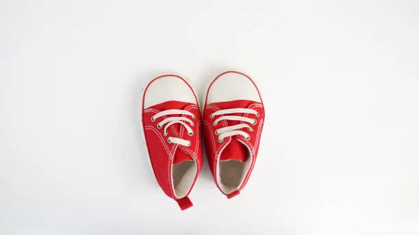baby red sneakers isolated on white background. baby shoes .
