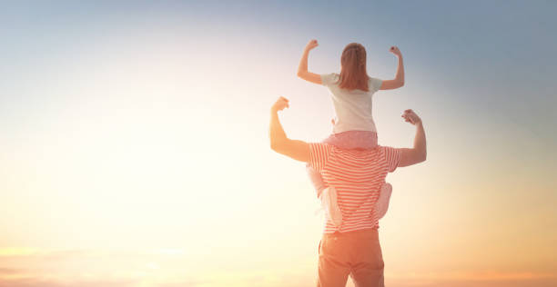 istock happy family at sunset. 1146033585