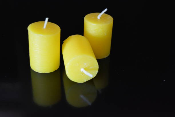istock On black glossy background, there is a yellow cloak with reflection. 1146033650